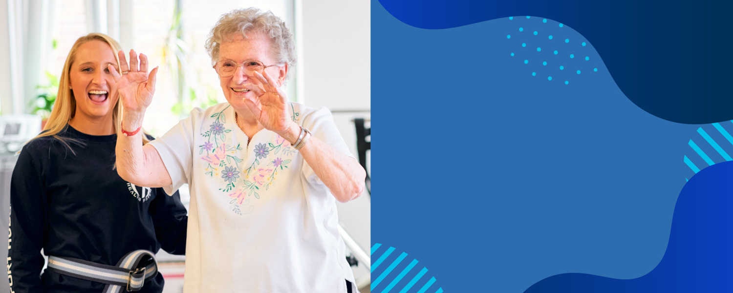 Fort Hudson Staff Member and Resident smile while catching a ball for personal training.